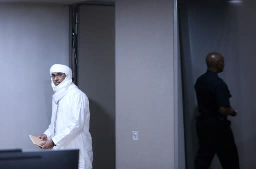Malian jihadist Al Hassan Ag Abdoul Aziz Ag Mohamed Ag Mahmoud enters the courtroom to face charges of war crimes