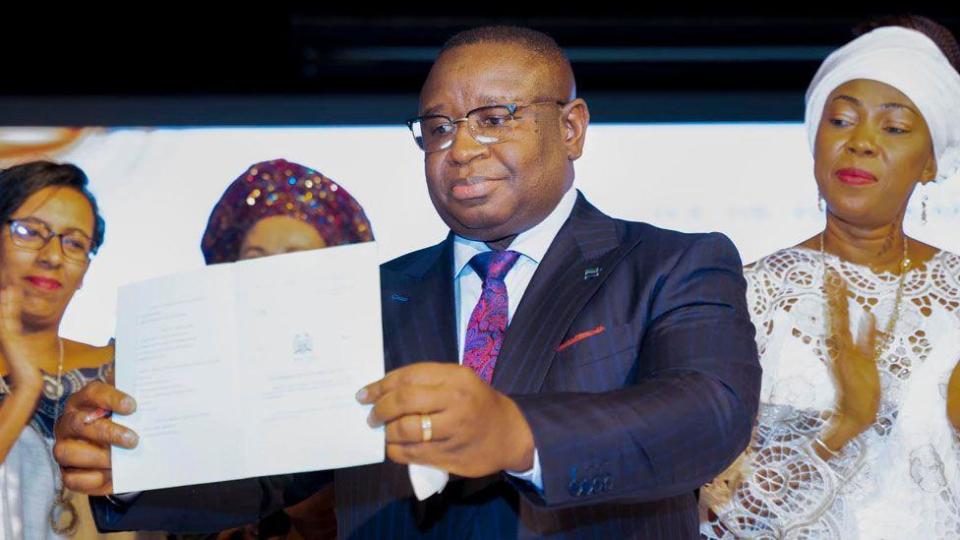 First Lady Fatima Bio (R) watches her husband hold the Prohibition of Child Marriage Act 