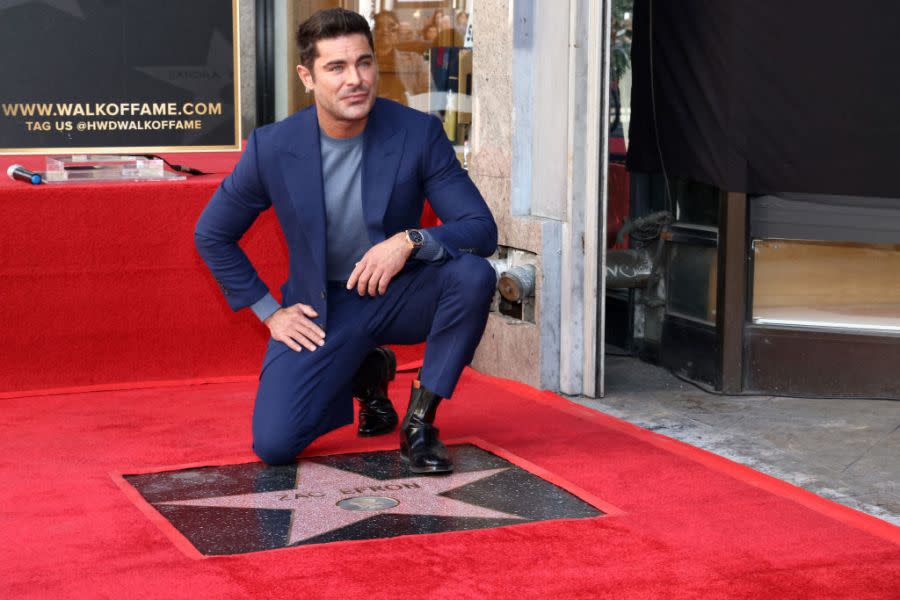 US actor Zac Efron poses by his newly unveiled star during his Hollywood Walk of Fame ceremony in Hollywood, California, December 11, 2023. (Photo by TOMMASO BODDI / AFP) (Photo by TOMMASO BODDI/AFP via Getty Images)