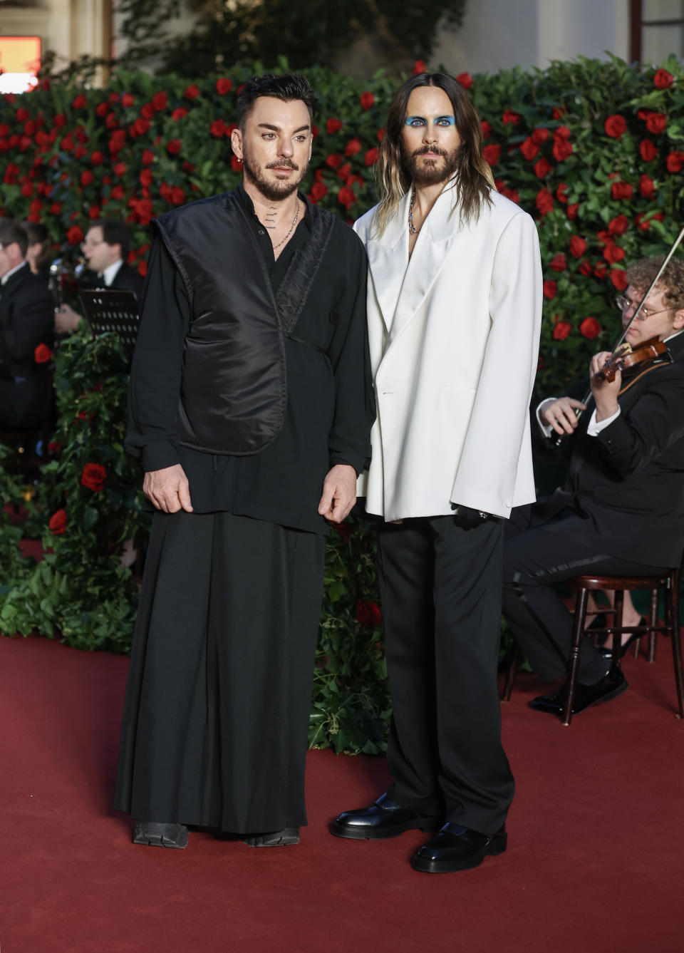 shannon wearing a long skirt and long-sleeved top and jared wearing dark pants and an oversized blazer