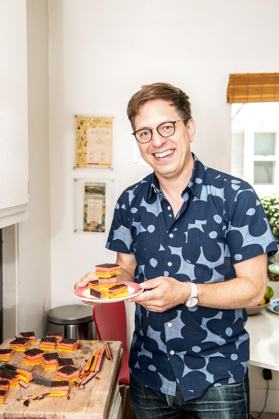 Dyed with his favorite colors, author Adam Roberts serves rainbow cookies with friends during Pride.