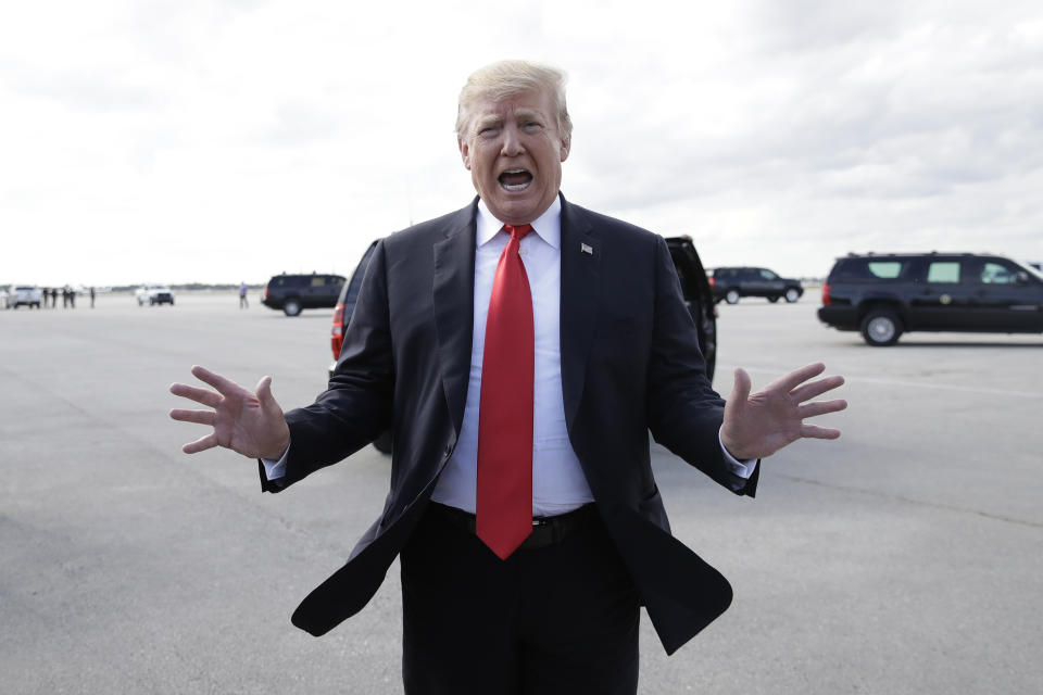 President Donald Trump talks to the media before boarding Air Force One, Sunday, March 24, 2019, at Palm Beach International Airport, in West Palm Beach, Fla., en route to Washington. In his first public comments since William Barr delivered his letter to Congress, Trump referred to Barr's summary of Robert Mueller's report as 'complete and total exoneration.' | Carolyn Kaster—AP