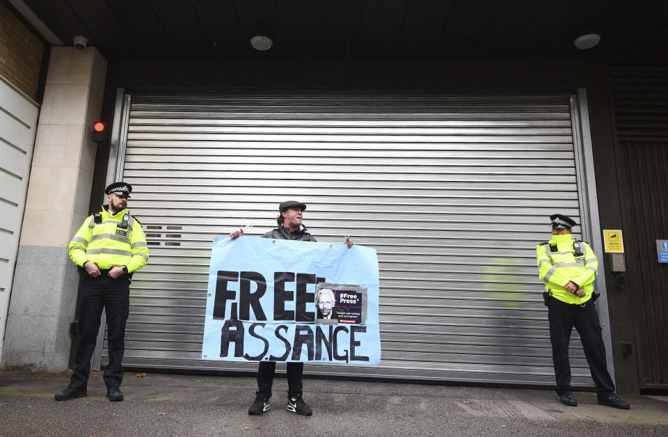 A supporters of Wikileaks founder Julian Assange demonstrate oustide Westminster Magistrates' Court in London where Assange is expected to appear as he fights extradition to the United States on charges of conspiring to hack into a Pentagon computer, in London, Monday, Oct, 21, 2019. U.S. authorities accuse Assange of scheming with former Army intelligence analyst Chelsea Manning to break a password for a classified government computer. (Victoria Jones/PA via AP)