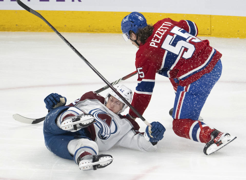 Montreal Canadiens left wing Michael Pezzetta (55) takes down Colorado Avalanche defenseman Josh Manson (42) during first-period NHL hockey game action Monday, Jan. 15, 2024, in Montreal. (Ryan Remiorz/The Canadian Press via AP)