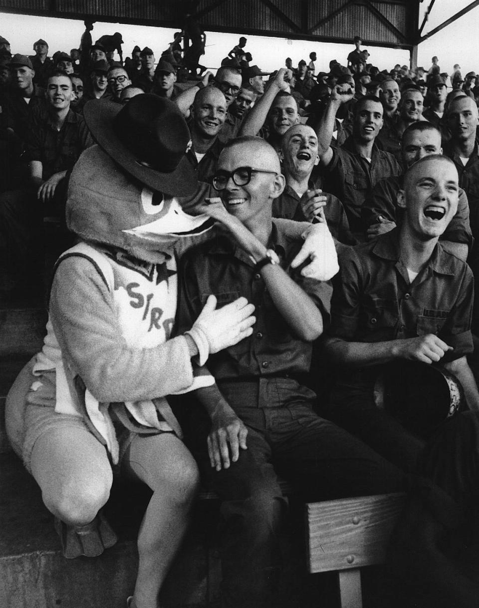 U.S. Army private Wade Fowble Gets his “orders” from Sgt. Duck at Golden Park in Columbus, Georgia during a baseball game.