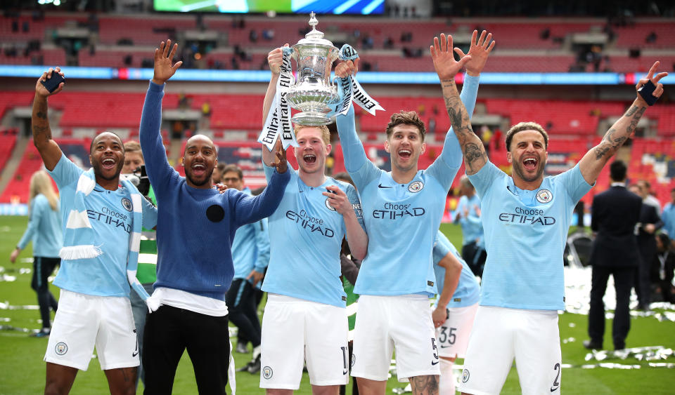 Manchester City's Raheem Sterling, Fabian Delph, Kevin De Bruyne, John Stones and Kyle Walker celebrate with the trophy after winning the FA Cup Final during the FA Cup Final at Wembley Stadium, London. (Photo by Nick Potts/PA Images via Getty Images)