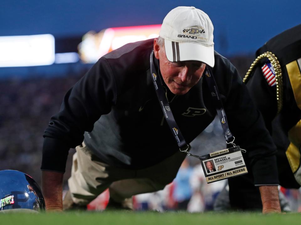 Purdue President Mitch Daniels does pushups after Purdue scores during the NCAA football game against the Florida Atlantic Owls, Saturday, Sept. 24, 2022, at Ross-Ade Stadium in West Lafayette, Ind. 