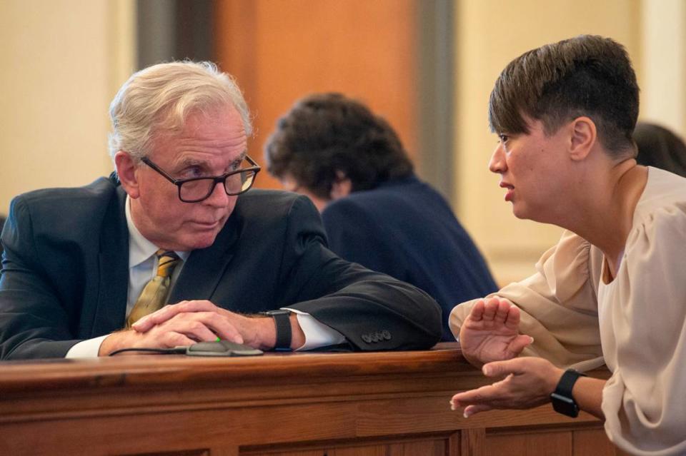 Ben Taylor’s wife Dorean Taylor talks with Branissa Stroud’s lawyer, Michael Holleman, during a court hearing for Taylor’s case against DHS at Hancock County Chancery Court in Bay St. Louis on Monday, Sept. 12, 2022.