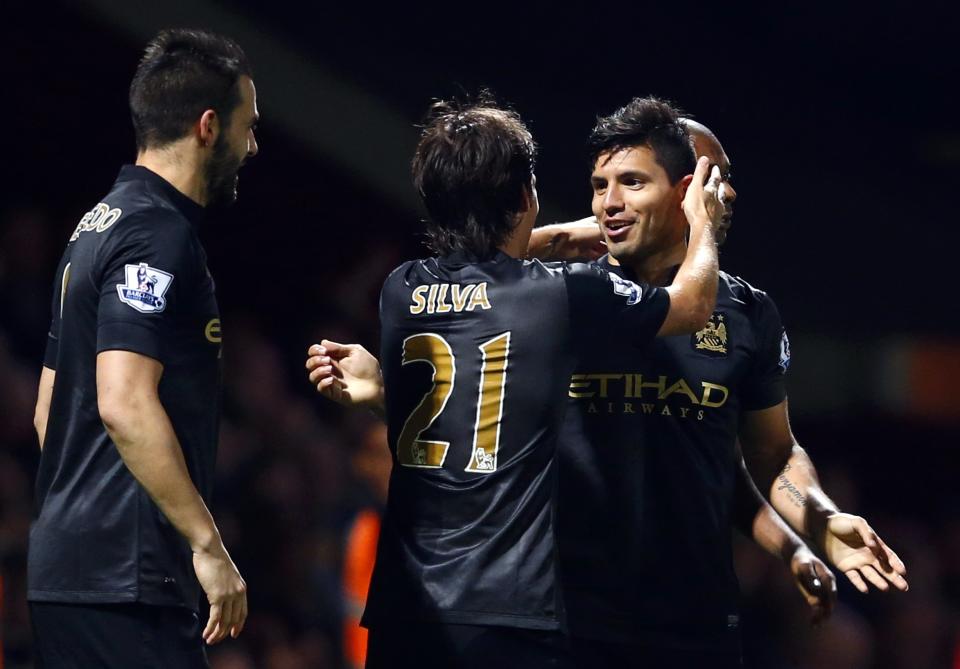 Manchester City's Aguero celebrates with teammmate Silva after scoring a goal against West Ham United during their English Premier League soccer match at the Boleyn Ground in London