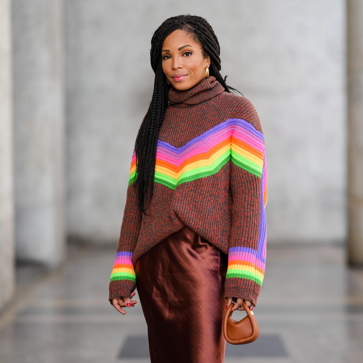  woman in colorful turtleneck and brown skirt 