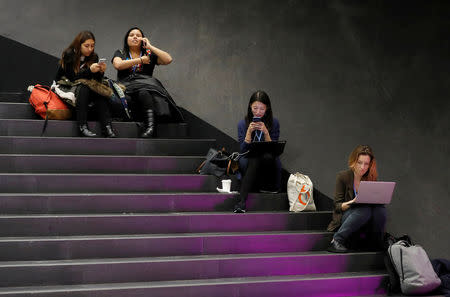 Participants sit on the stairs inside the venue, before the final session of the COP24 U.N. Climate Change Conference 2018 in Katowice, Poland, December 14, 2018. REUTERS/Kacper Pempel