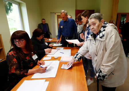 People attend the first round of Lithuanian Presidential election in Vilnius, Lithuania May 12, 2019. REUTERS/Ints Kalnins