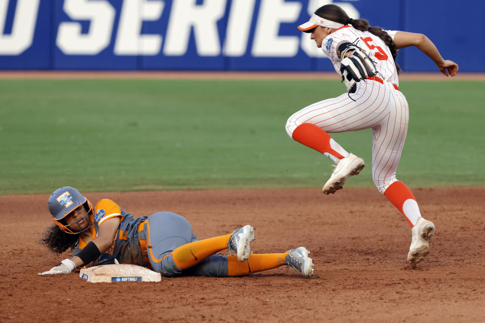 Tennessee's Rylie West, left, steals second base past Oklahoma State's Kiley Naomi during the fifth inning of an NCAA softball Women's College World Series game, Sunday, June 4, 2023, in Oklahoma City. (AP Photo/Nate Billings)