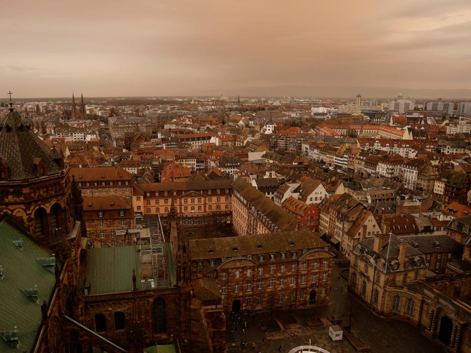 Taken from the top of the Strasbourg cathedral, the eastern France city of Strasbourg seems to be covered by an orange light as Sahara dust is moving in over the city, coloring the sky, Tuesday March 15, 2022. Storms in the Sahara desert create large gusts of wind, which lift the sand into the air. (AP Photo/Jean-Francois Badias)