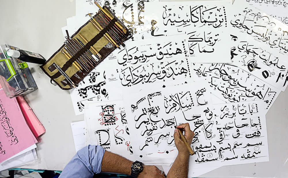 A man practises khat calligraphy in Balik Pulau, Penang. — Picture by Sayuti Zainudin