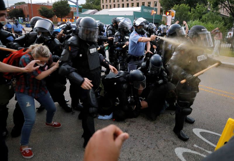 FILE PHOTO: A police officer discharges pepper spray during nationwide unrest following the death in Minneapolis police custody of George Floyd, in Raleigh