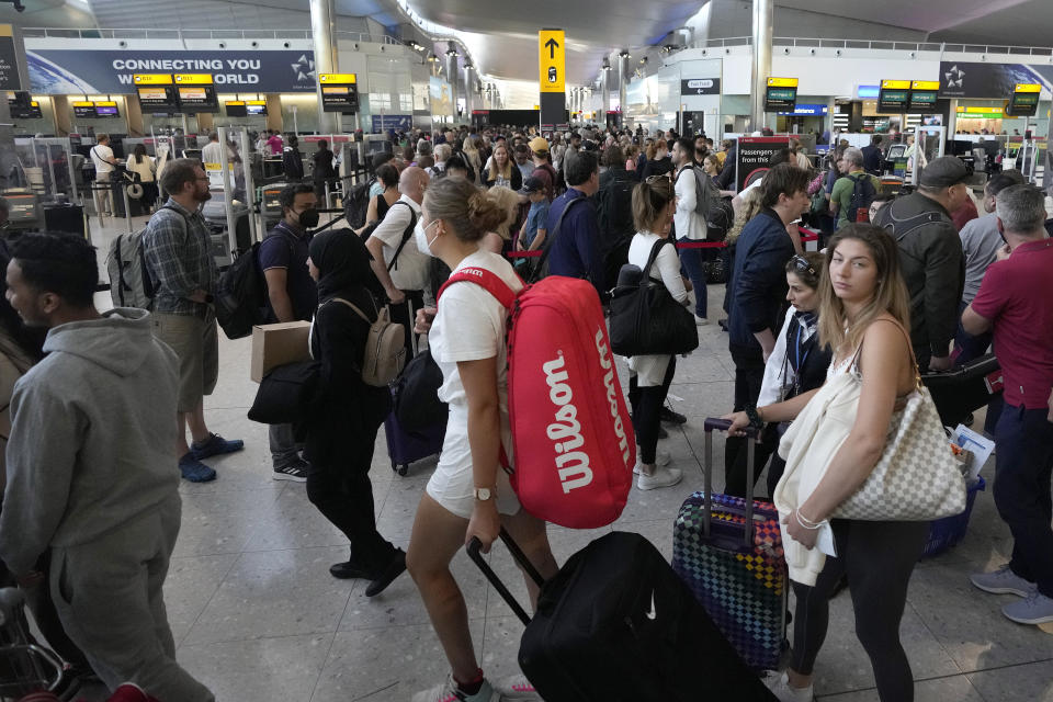 Travellers queue at security at Heathrow Airport in London, Wednesday, June 22, 2022. After two years of pandemic restrictions, travel demand is back with a vengeance but airlines and airports that slashed jobs during the depths of the COVID-19 crisis are struggling to keep up. With the busy summer tourism season underway in Europe, passengers are encountering chaotic scenes at airports, including lengthy delays, canceled flights and headaches over lost luggage. (AP Photo/Frank Augstein)