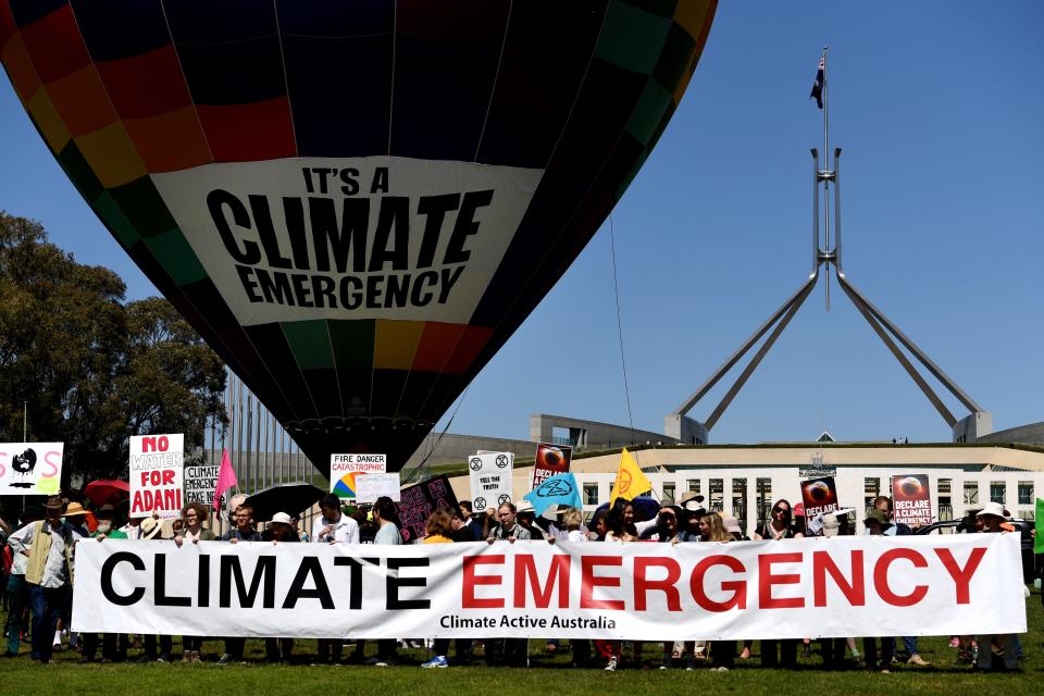 A hot air balloon with 'Climate Emergency' on it is seen in front of Parliament House on October 15, 2019, in Canberra, Australia. Protesters are demanding politicians declare a climate emergency.