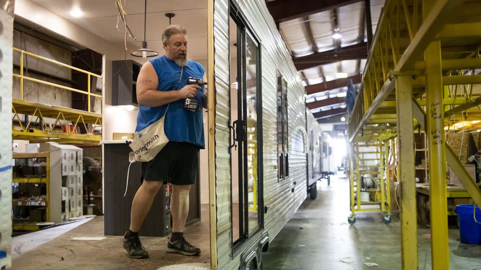 A worker installs interior wiring on a destination recreational vehicle at the HL Enterprise manufacturing facility in Elkhart, Indiana, on October 8, 2020. - Ty Wright/Bloomberg/Getty Images