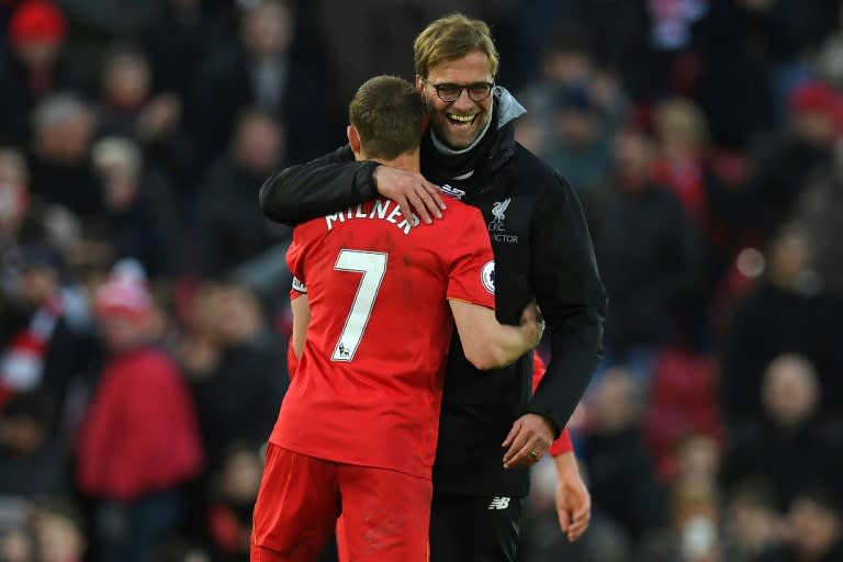 Liverpool's manager Jurgen Klopp (R) embraces midfielder James Milner after their English Premier League match against Burnley, at Anfield in Liverpool, on March 12, 2017