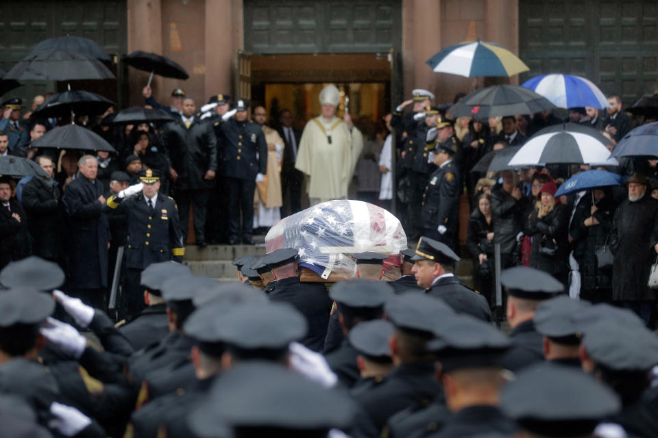 Pallbearers transport the casket of Jersey City Police Detective Joseph Seals in to St. Aeden's church for the funeral services in Jersey City, N.J., Tuesday, Dec. 17, 2019. The 40-year-old married father of five was killed in a confrontation a week ago with two attackers who then drove to a kosher market and killed three people inside before dying in a lengthy shootout with police. (AP Photo/Seth Wenig)