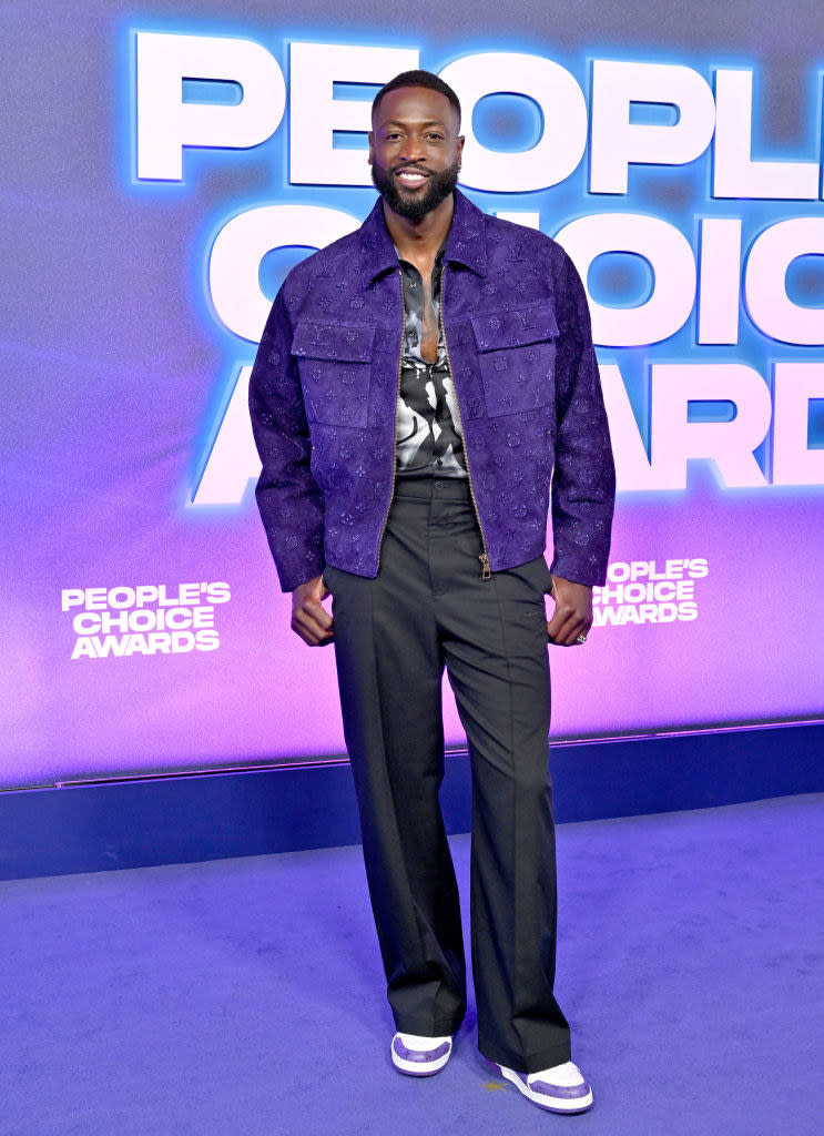 Dwyane Wade attends the 2022 People's Choice Awards in slacks and a jacket