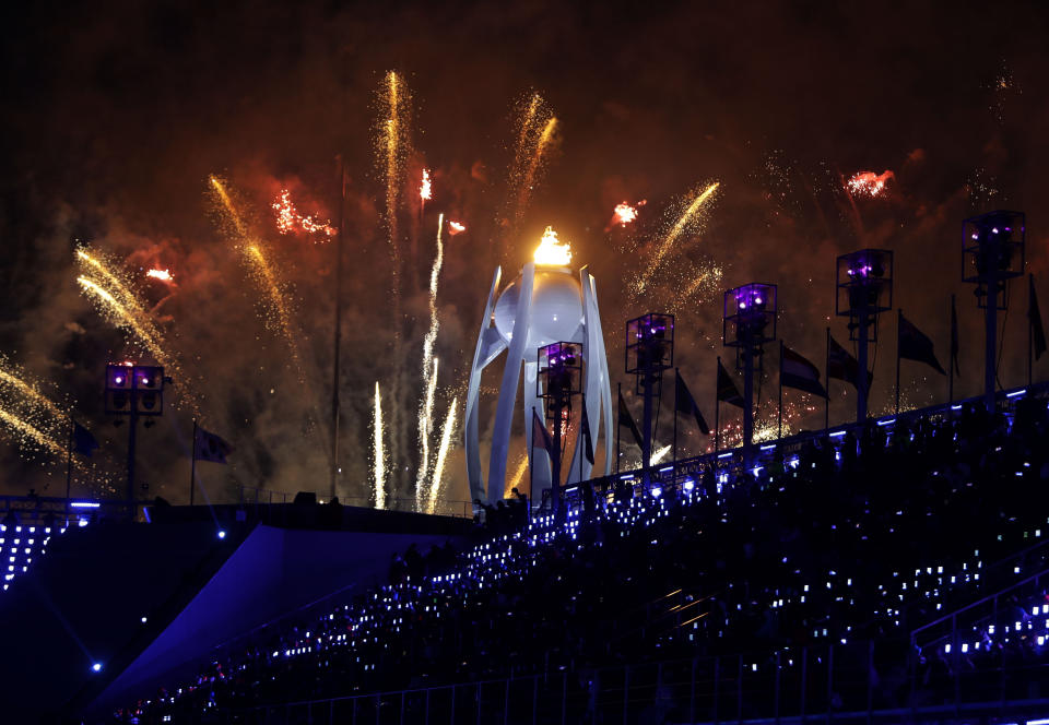 Fireworks explode over the Olympic flame during the closing ceremony of the 2018 Winter Olympics in Pyeongchang, South Korea, Sunday, Feb. 25, 2018. (AP Photo/Michael Probst)