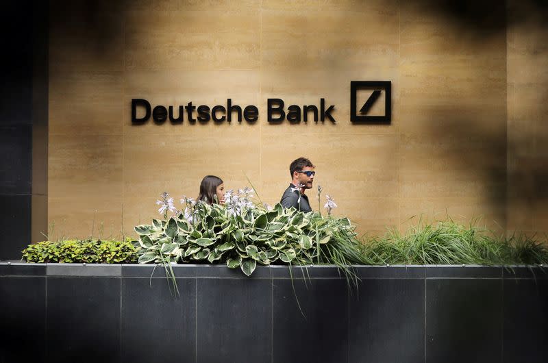 FILE PHOTO: People walk past a Deutsche Bank office in London