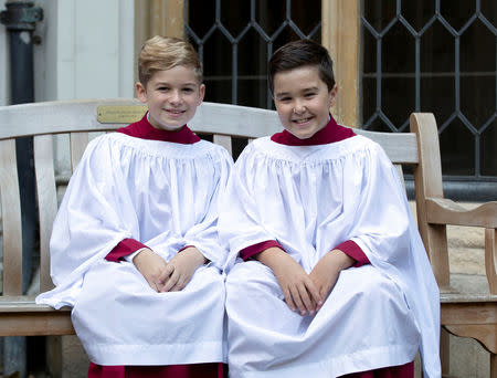 Choristers from the Windsor Castle Chapel Choir, Leo Mills, aged 12, and Alexis Sheppard, aged 11, who will take part in the wedding of Princess Eugenie and Jack Brooksbank, pose outside the chapel in Windsor, Britain, October 11, 2018. Steve Parsons/Pool via REUTERS