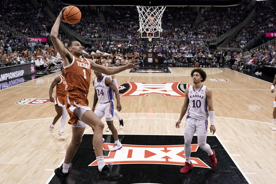 Texas forward Dylan Disu (1) dunks the ball during the first half of the NCAA college basketball championship game against Kansas in the Big 12 Conference tournament Saturday, March 11, 2023, in Kansas City, Mo. (AP Photo/Charlie Riedel)