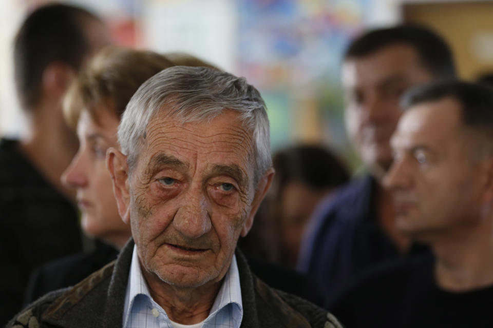 Bosnian people wait in a line to cast their votes at a polling station in Sarajevo, Bosnia, on Sunday, Oct. 7, 2018. Bosnians were voting Sunday in a general election that could install a pro-Russian nationalist to a top post and cement the ethnic divisions of a country that faced a brutal war 25 years ago. (AP Photo/Amel Emric)