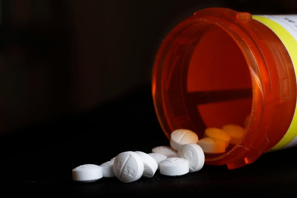 FILE - An arrangement of Oxycodone pills sit next to a bottle. (AP Photo/Mark Lennihan, File)