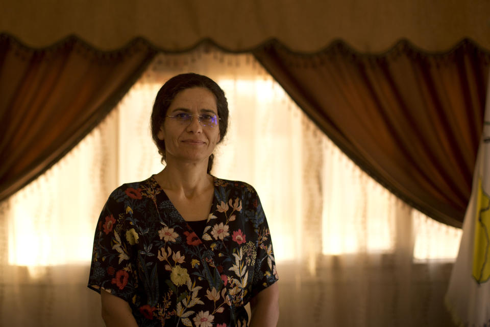 In this Tuesday, Sept. 3, 2019 photo, Ilham Ahmed, co-chair of the executive committee of the U.S-backed Syrian Democratic Council, speaks during an interview in Darbasiyah, Syria. Ahmed said Tuesday that the creation of a so-called “safe zone” in northeastern Syria is off to good start, with U.S.-backed Kurdish-led forces pulling back from an initial part of the border with Turkey, but calm can only prevail if Turkey also removes its troops. (AP Photo/Maya Alleruzzo)