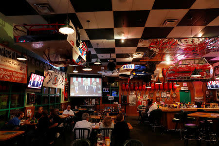 Diners watch as President Donald Trump speaks to congress during a Pinellas County Republican Party watch party in Clearwater, Florida, U.S. February 28, 2017. REUTERS/Scott Audette