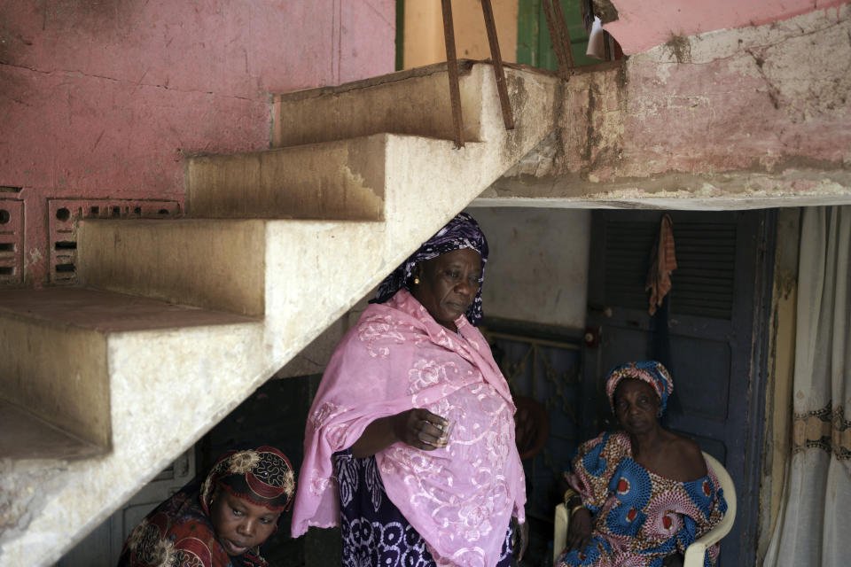Seynabou Diop, center, stands with her relatives in their home after talking about her son, Khadim Ba, 21, who died during the protests earlier this month in Dakar, Senegal, Thursday, June 15, 2023. "If I had known (he was going to protest), Khadim would never have taken part," said Diop. "I want (the government) to meet the expectations of young people, the government has an obligation to help (them)," she said. (AP Photo/Leo Correa)