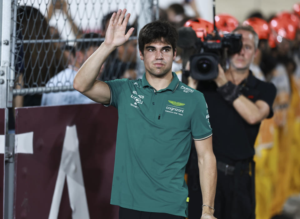 LUSAIL CITY, QATAR - OCTOBER 8: Lance Stroll of Canada and Aston Martin Aramco Cognizant F1 Team waves to the crowd before the F1 Grand Prix of Qatar at Lusail International Circuit on October 8, 2023 in Lusail City, Qatar. (Photo by Qian Jun/MB Media/Getty Images)
