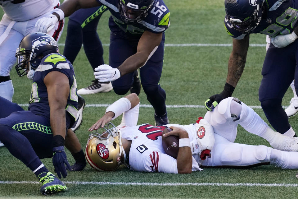 San Francisco 49ers quarterback Jimmy Garoppolo reacts after he was sacked by Seattle Seahawks middle linebacker Bobby Wagner during the first half of an NFL football game, Sunday, Nov. 1, 2020, in Seattle. (AP Photo/Elaine Thompson)