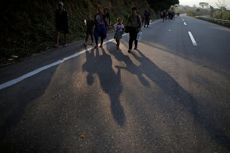 Central American migrants walk during their journey towards the United States, in Mapastepec, Mexico April 20, 2019. REUTERS/Jose Cabezas