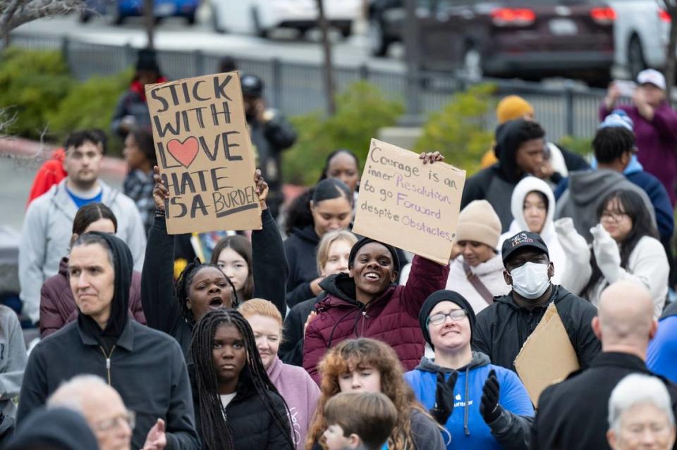 People in the crowd hold up signs before the start of the in MLK365 March for the Dream honoring Martin Luther King Jr. on Monday at Sacramento City College. More than 2,000 people participated in the march. Sara Nevis/snevis@sacbee.com