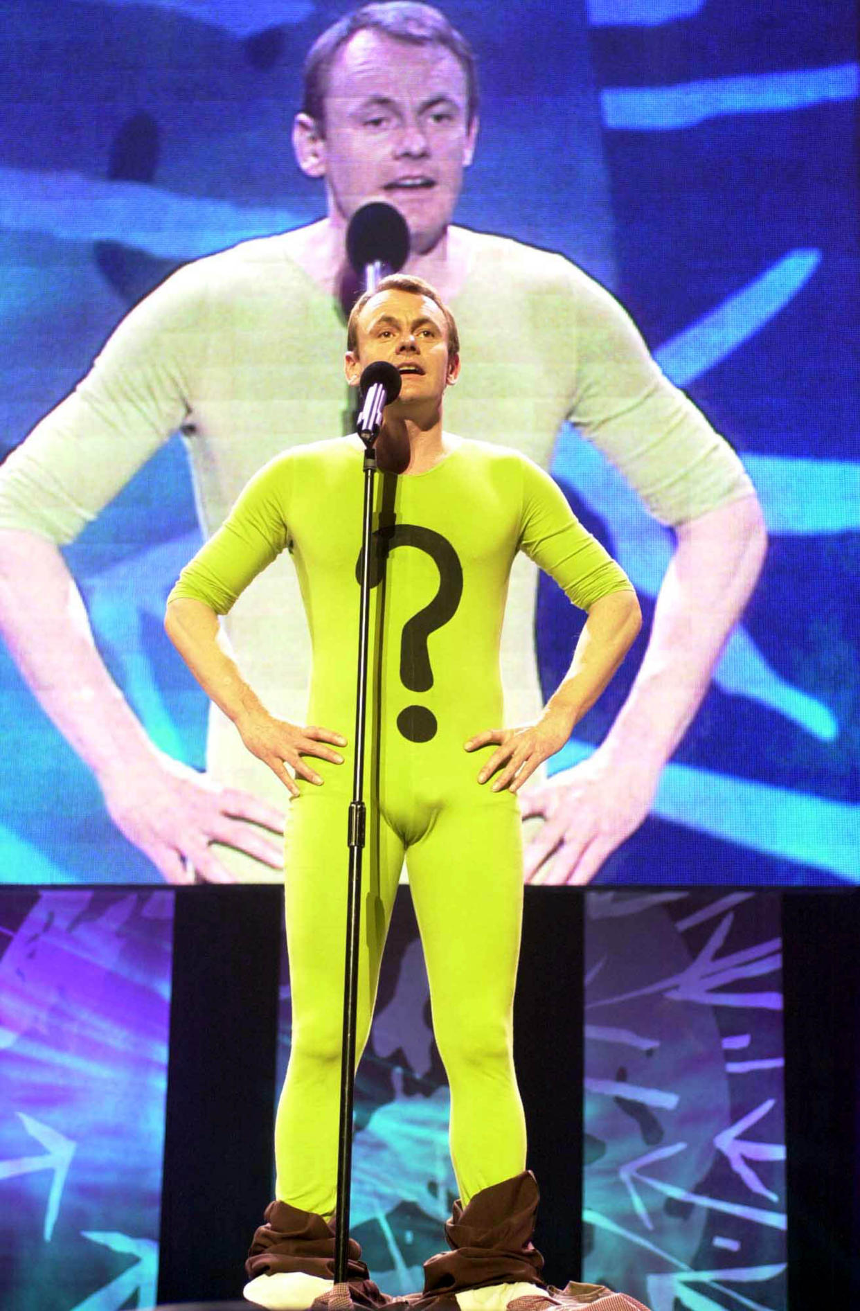 File photo dated 03/06/01 of comedian Sean Lock performing on stage during the 'We Know Where You Live. Live!' event to mark the 40th anniversary of Amnesty International at Wembley Arena. Sean Lock, best known for panel shows 8 Out Of 10 Cats and 8 Out Of 10 Cats Does Countdown, as well as sitcom 15 Storeys High, has died from cancer at the age of 58. Issue date: Wednesday August 18, 2021.