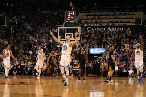 Golden State star Stephen Curry reacts after hitting a three-point shot in the second half of the Warriors' 117-107 NBA victory over the Phoenix Suns