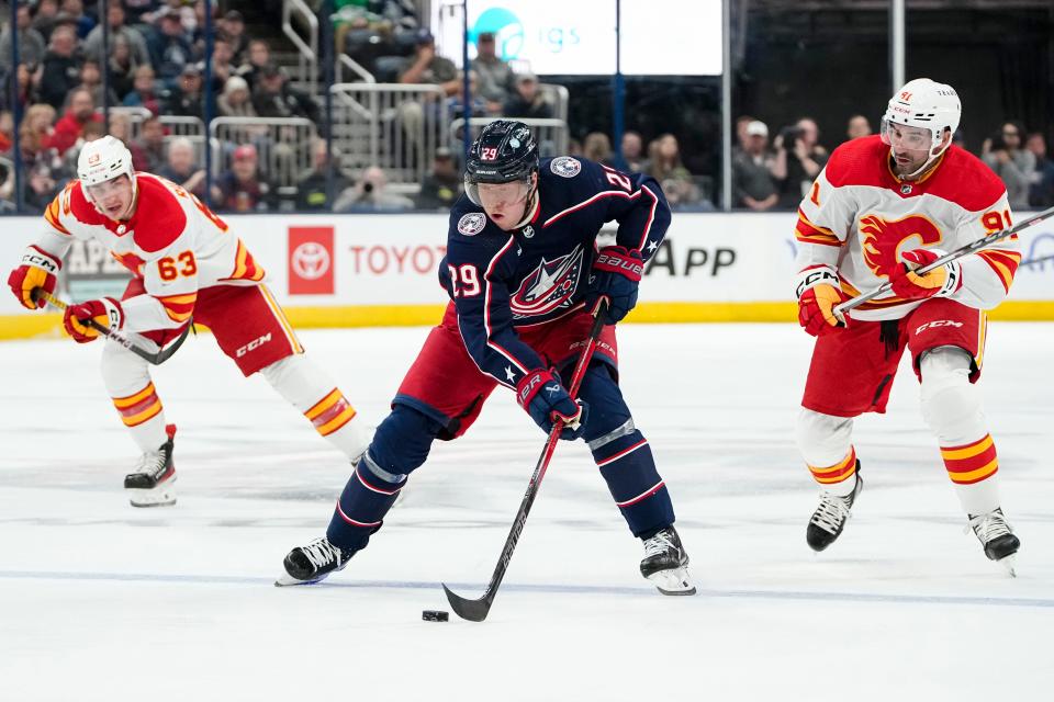 Oct 20, 2023; Columbus, Ohio, USA; Columbus Blue Jackets right wing Patrik Laine (29) skates up ice past Calgary Flames center Nazem Kadri (91) and center Adam Ruzicka (63) during the first period of the NHL hockey game at Nationwide Arena.