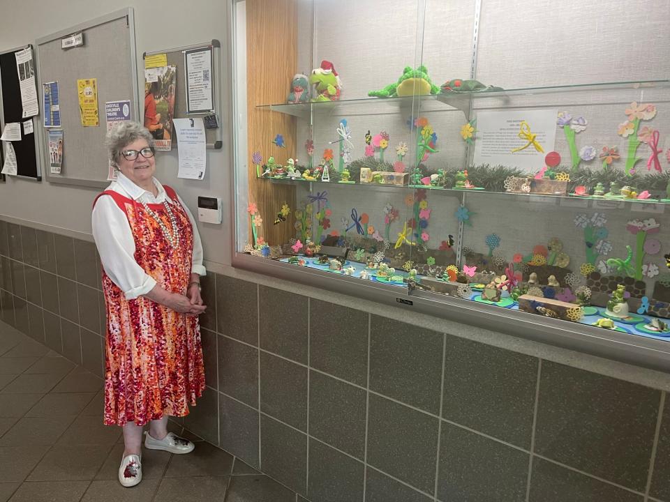 Fountain City Library branch manager Elizabeth Nelson shows off the Martinson Frogs − a collection of figurines willed to the Knox County Public Library by former head archivist Doris Martinson, who died in 2021.