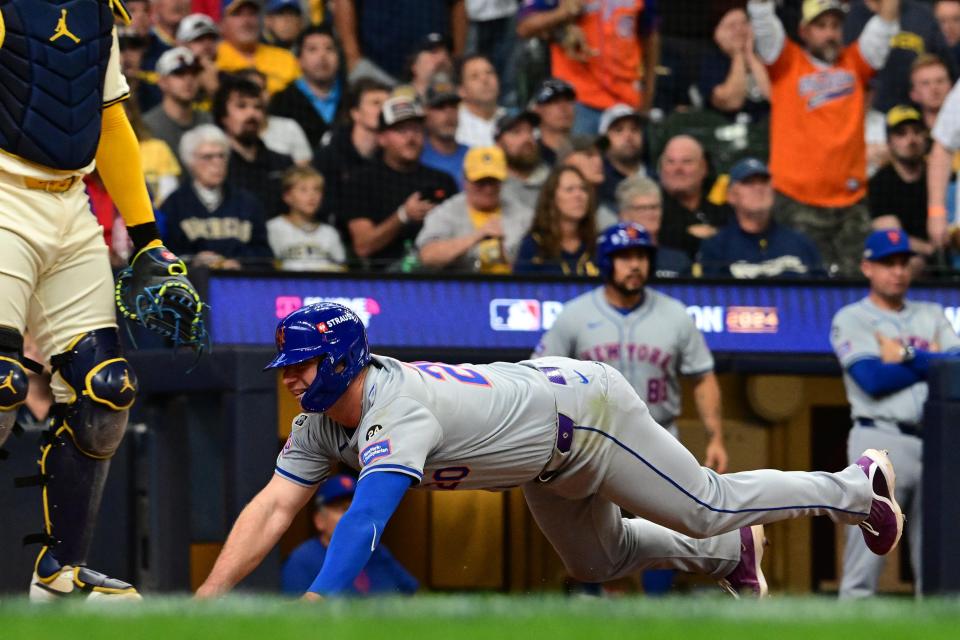 Oct. 1: New York Mets first baseman Pete Alonso slides safely into home plate during the second inning.