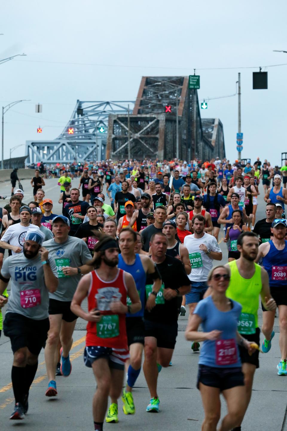 The 25th Flying Pig Marathon takes place Sunday, and there are festivities taking place all weekend long. Pictured: Runners cross the Clay Wade Bailey Bridge during the 2022 Flying Pig Marathon.