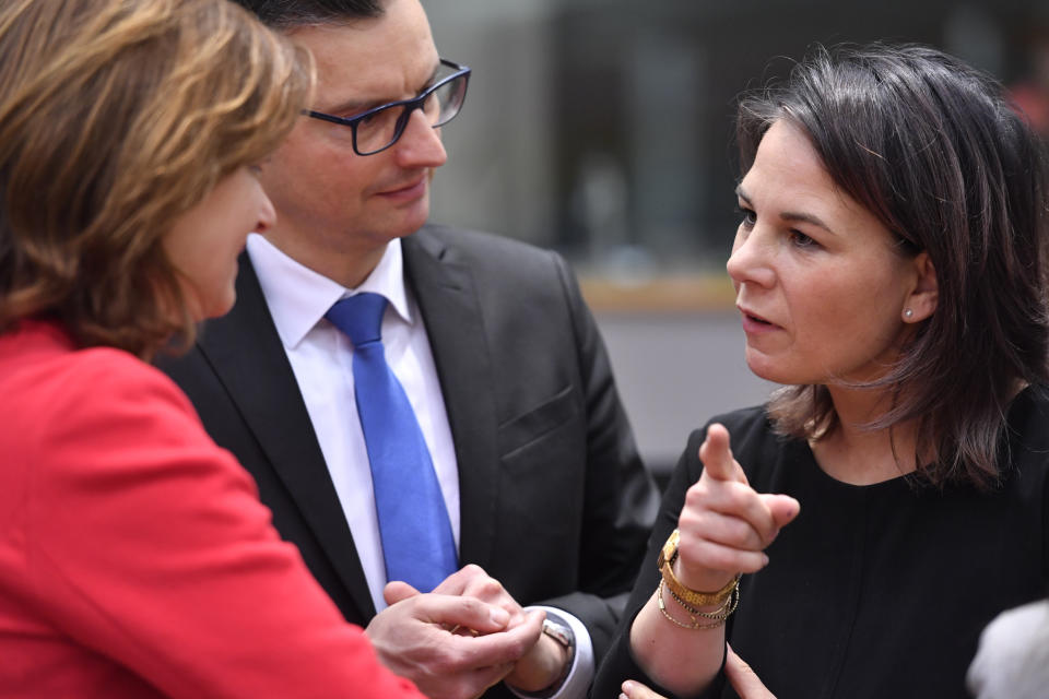 Germany's Foreign Minister Annalena Baerbock, right, speaks with Slovenia's Foreign Minister Tanja Fajon, left, and Slovenia's Defense Minister Marjan Sarec, center, during a meeting of EU foreign and defense ministers at the European Council building in Brussels on Monday, March 20, 2023. European Union foreign ministers on Monday will discuss the situation in Ukraine and Tunisia. (AP Photo/Geert Vanden Wijngaert)