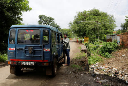 A policeman cleans his vehicle as its parked at the site where Mohammed Azam was killed in a mob lynching attack in Mukri village in Bidar, India, July 19, 2018. REUTERS/Danish Siddiqui