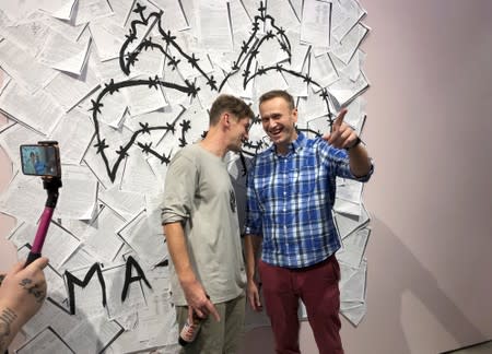 Russian opposition leader Alexei Navalny and his brother Oleg open an exhibition of drawings of prison-style tattoos in Moscow