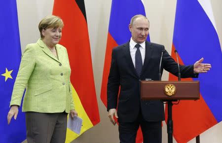 Russian President Vladimir Putin and German Chancellor Angela Merkel leave a joint news conference following their talks at the Bocharov Ruchei state residence in Sochi, Russia, May 2, 2017. REUTERS/Alexander Zemlianichenko/Pool