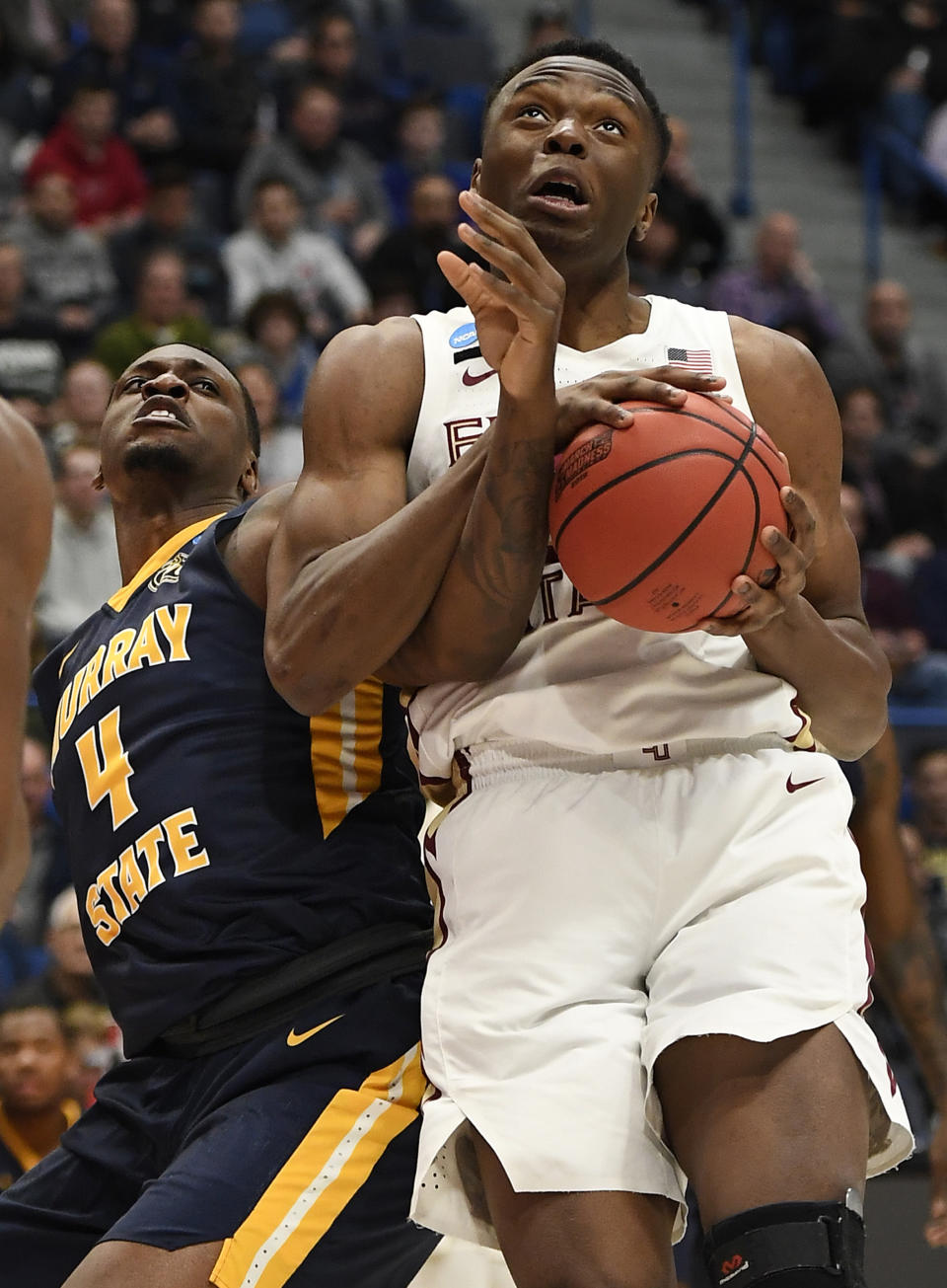 <p>Florida State’s Mfiondu Kabengele (25) tangles with Murray State’s Brion Sanchious (4) as he pulls down a rebound during the first half of a second round men’s college basketball game in the NCAA tournament, Saturday, March 23, 2019, in Hartford, Conn. (AP Photo/Jessica Hill) </p>